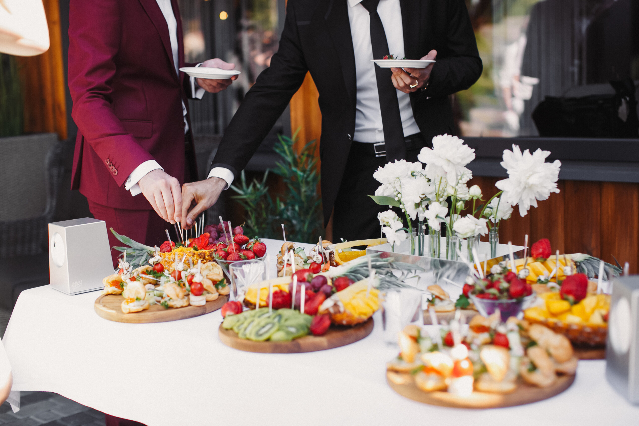 Close up of people serving themselves with fruits in buffet of r